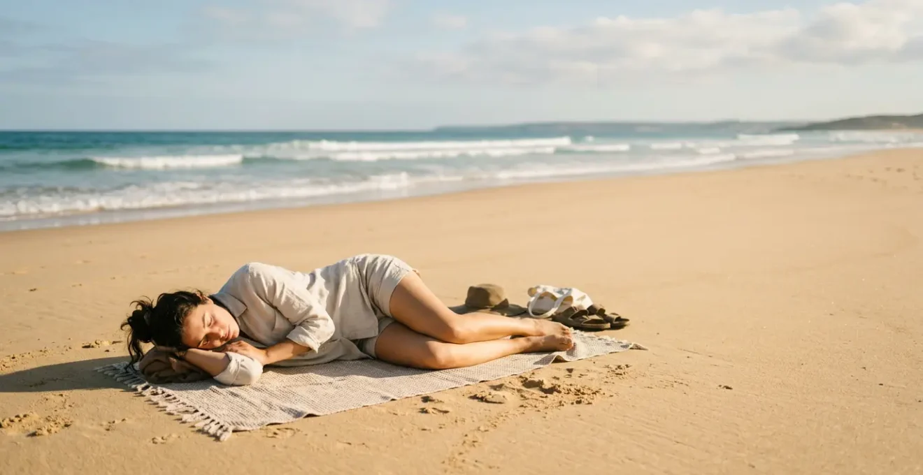 Personne reposant paisiblement sur le sable d'une plage ensoleillée avec les vagues en arrière-plan, incarnant l'art de la sieste côtière